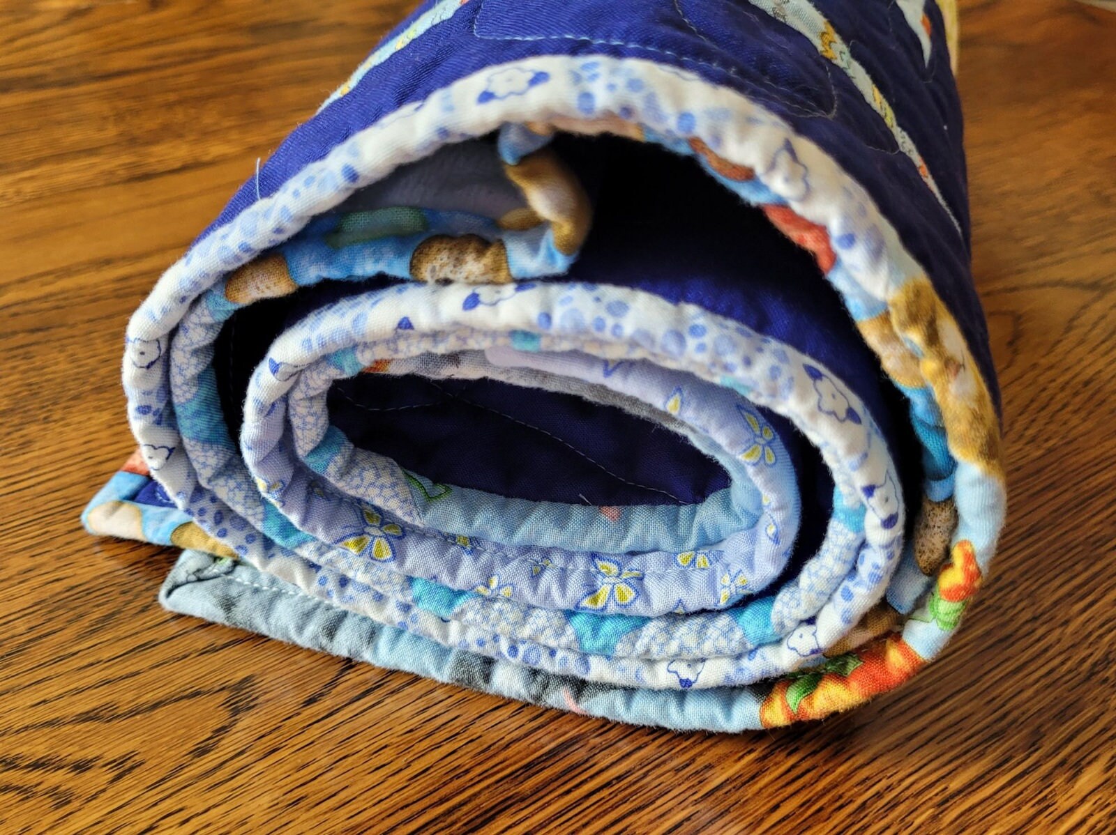 baby boy quilt in animal prints with navy blue background