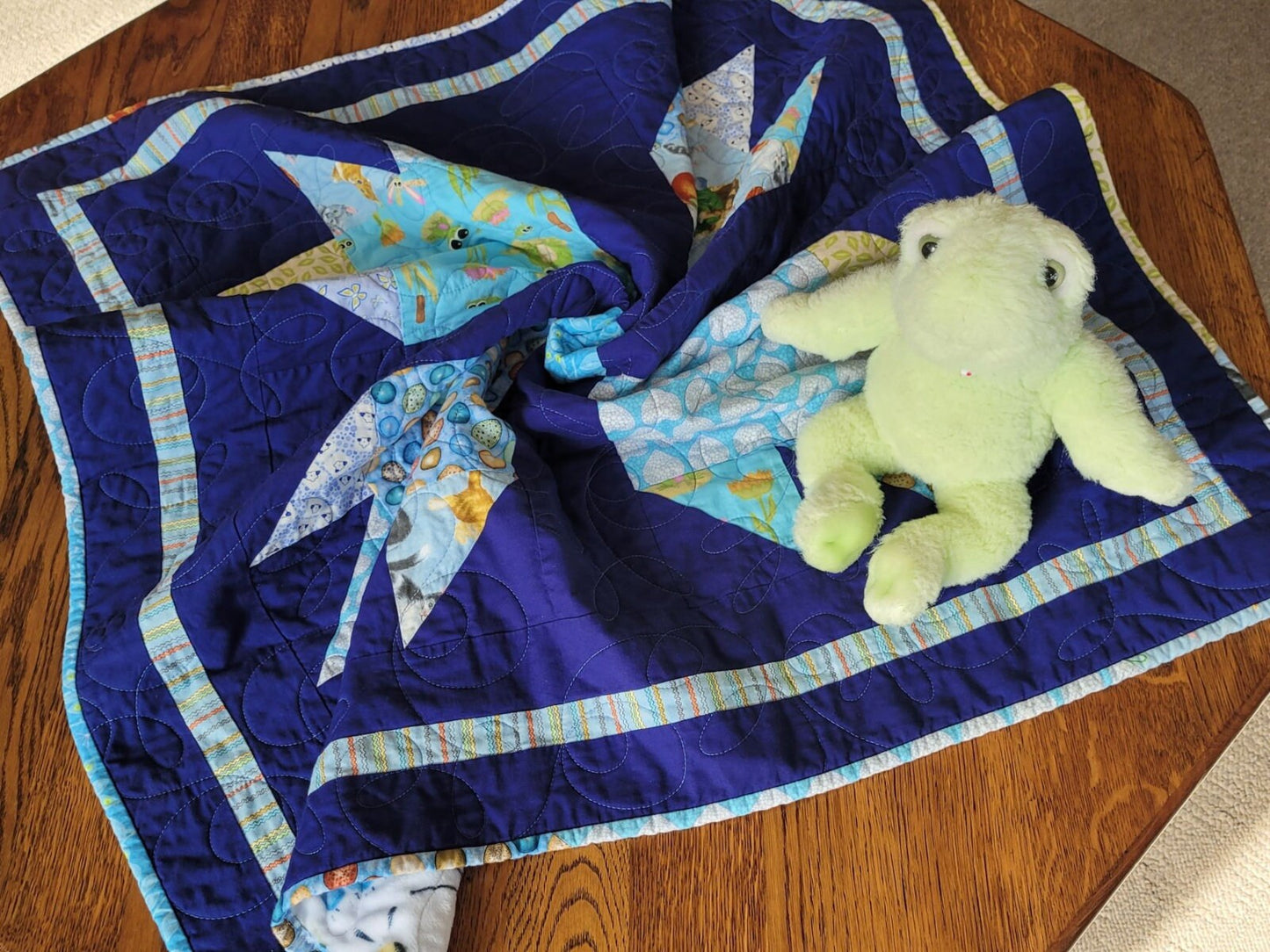 baby boy quilt in animal prints with navy blue background