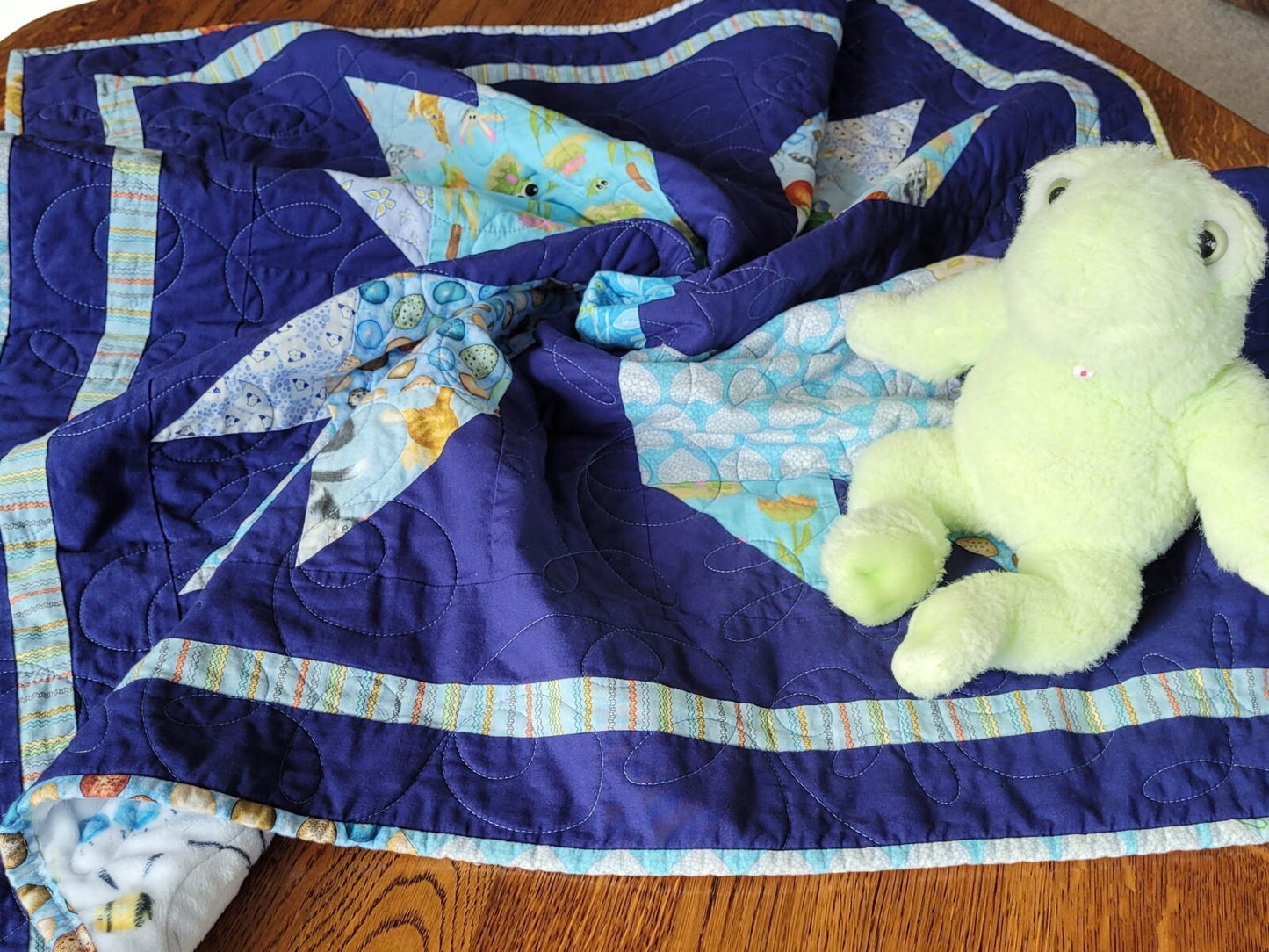 baby boy quilt in animal prints with navy blue background