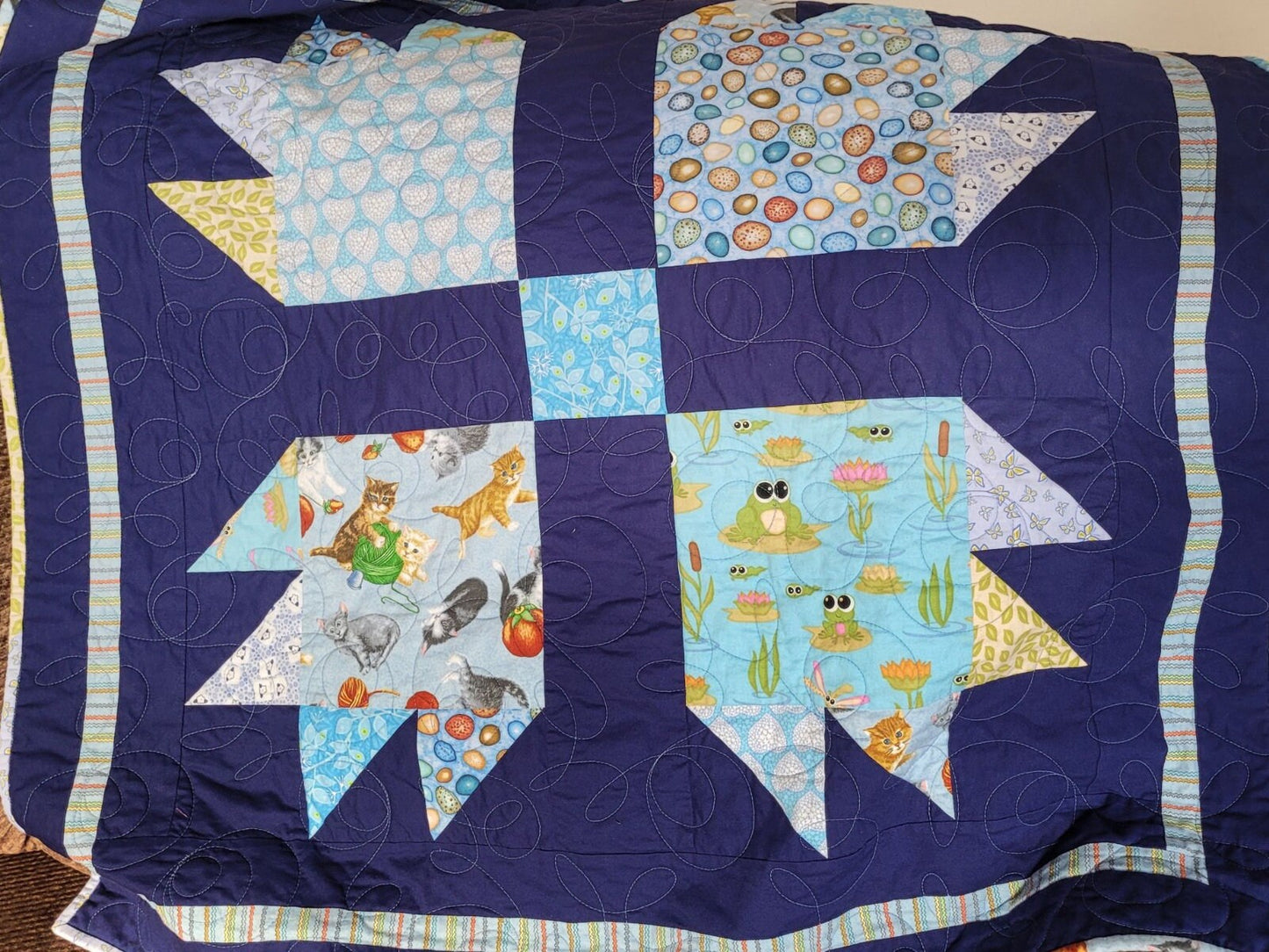 baby boy quilt in animal prints with navy blue background