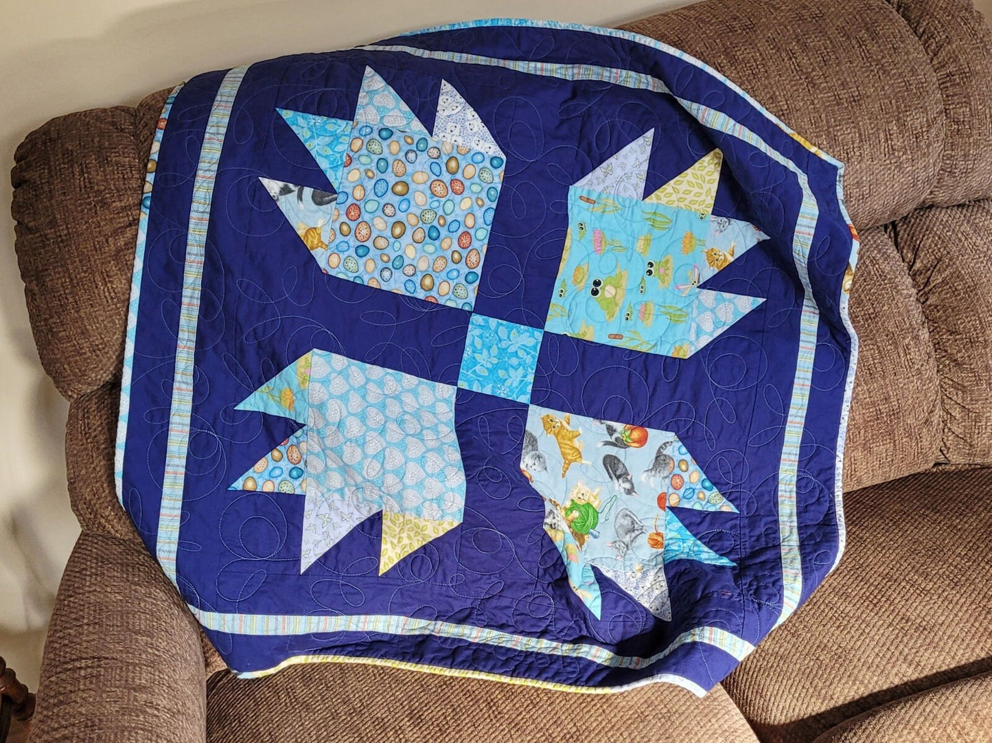 baby boy quilt in animal prints with navy blue background