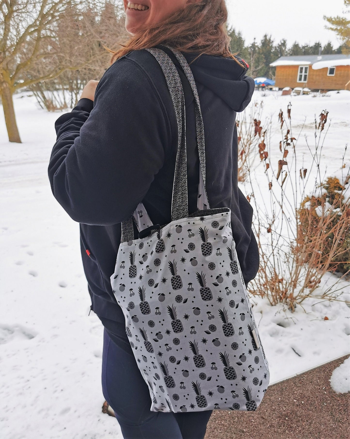 tote bag shown hanging over shoulder