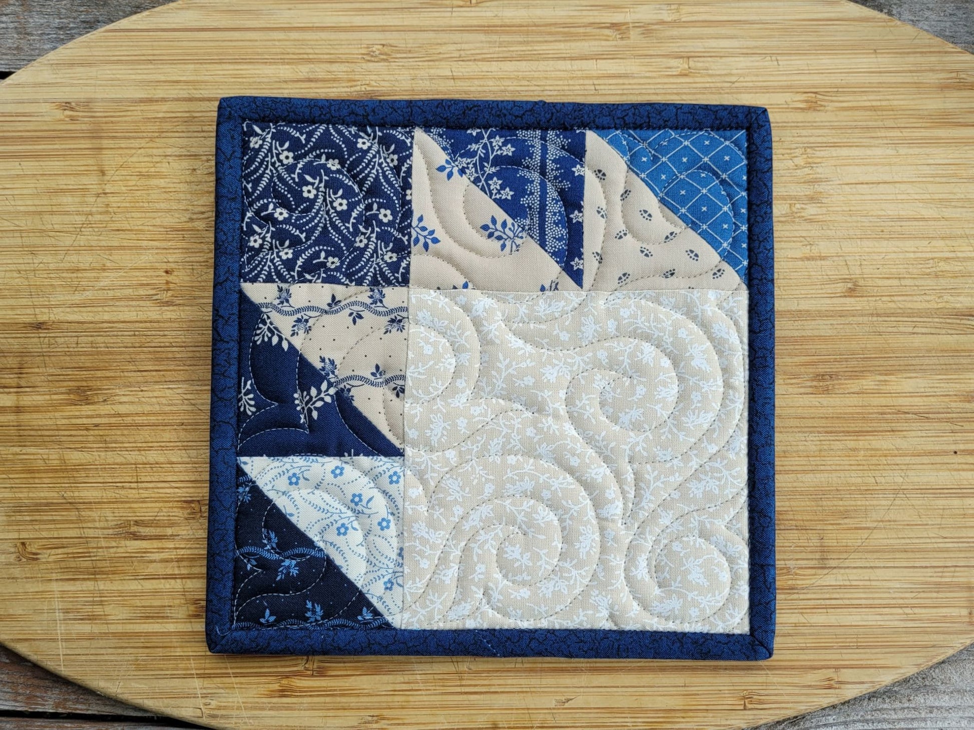 bear paw quilted pot holder in blue and beige cotton prints
