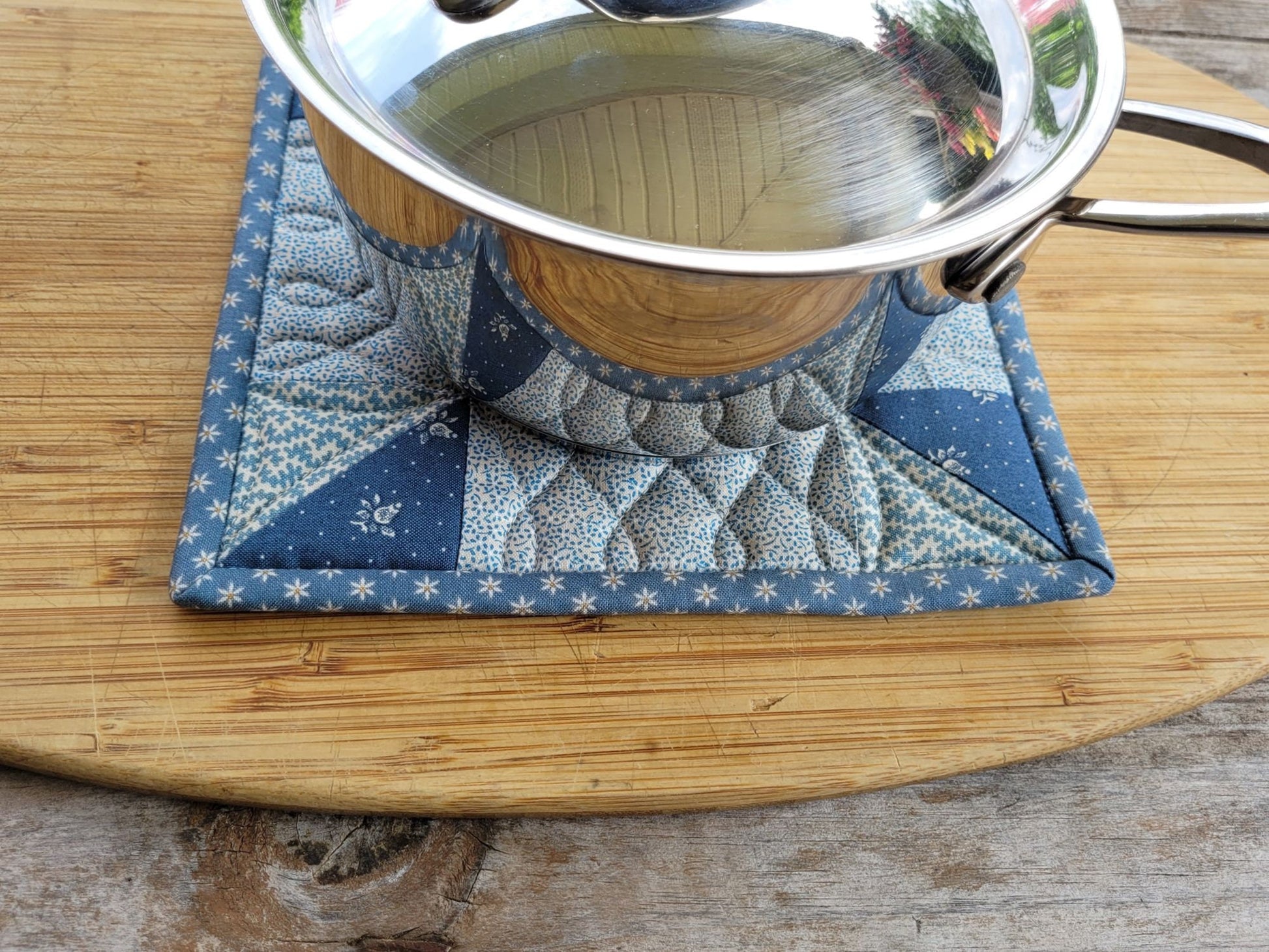 quilted potholder under a small size saucepan