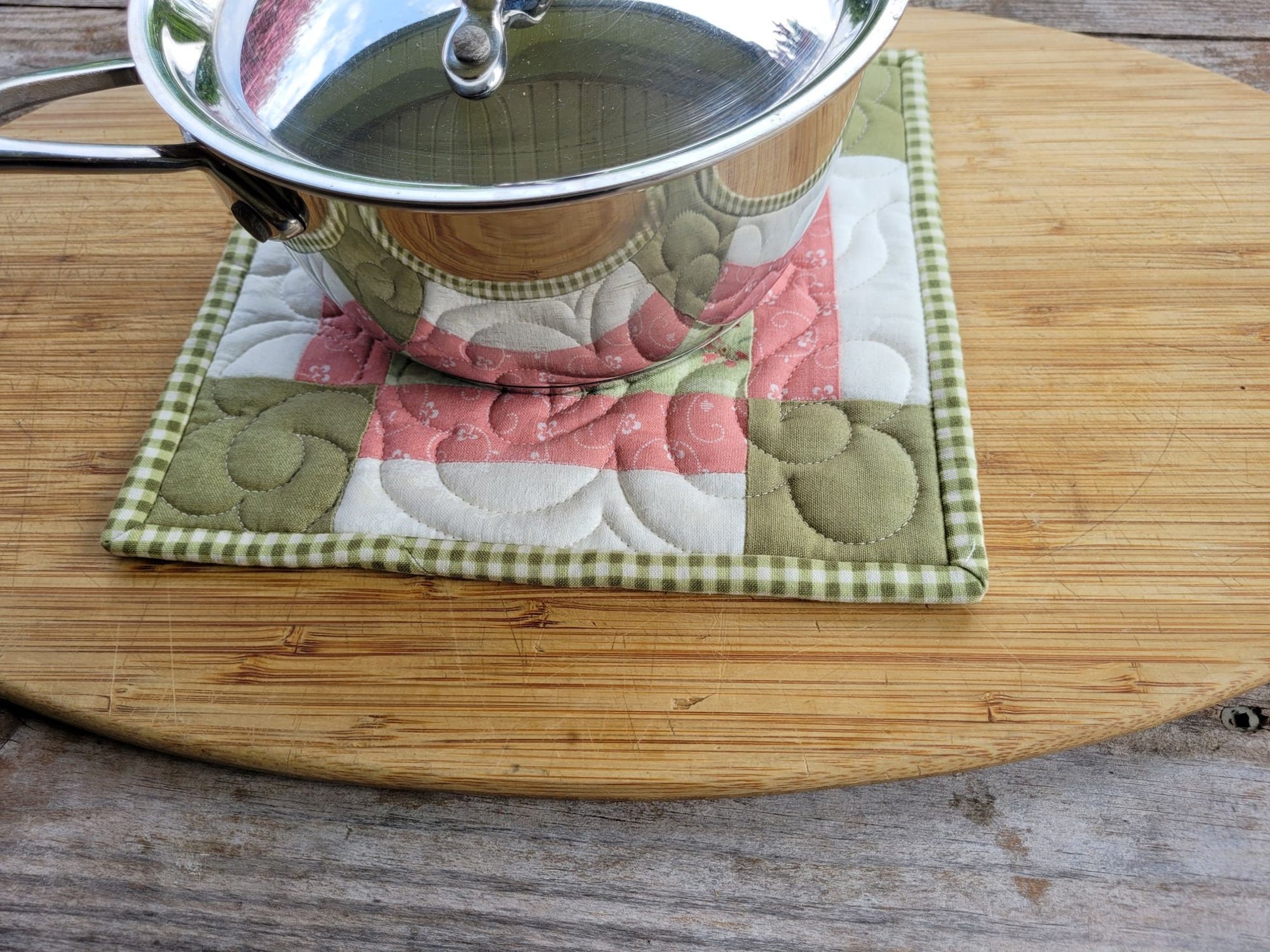 quilted patchwork potholder under a small size saucepan