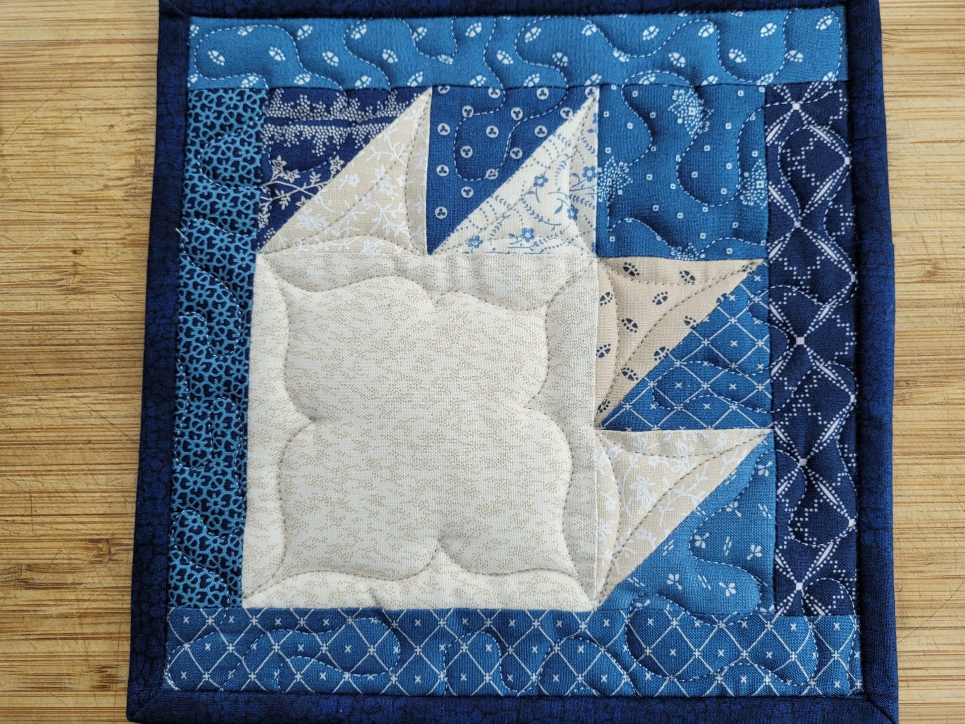 quilted potholder in blue bear paw design