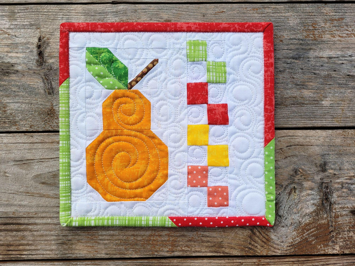 mini scrap quilt with orange patchwork pear