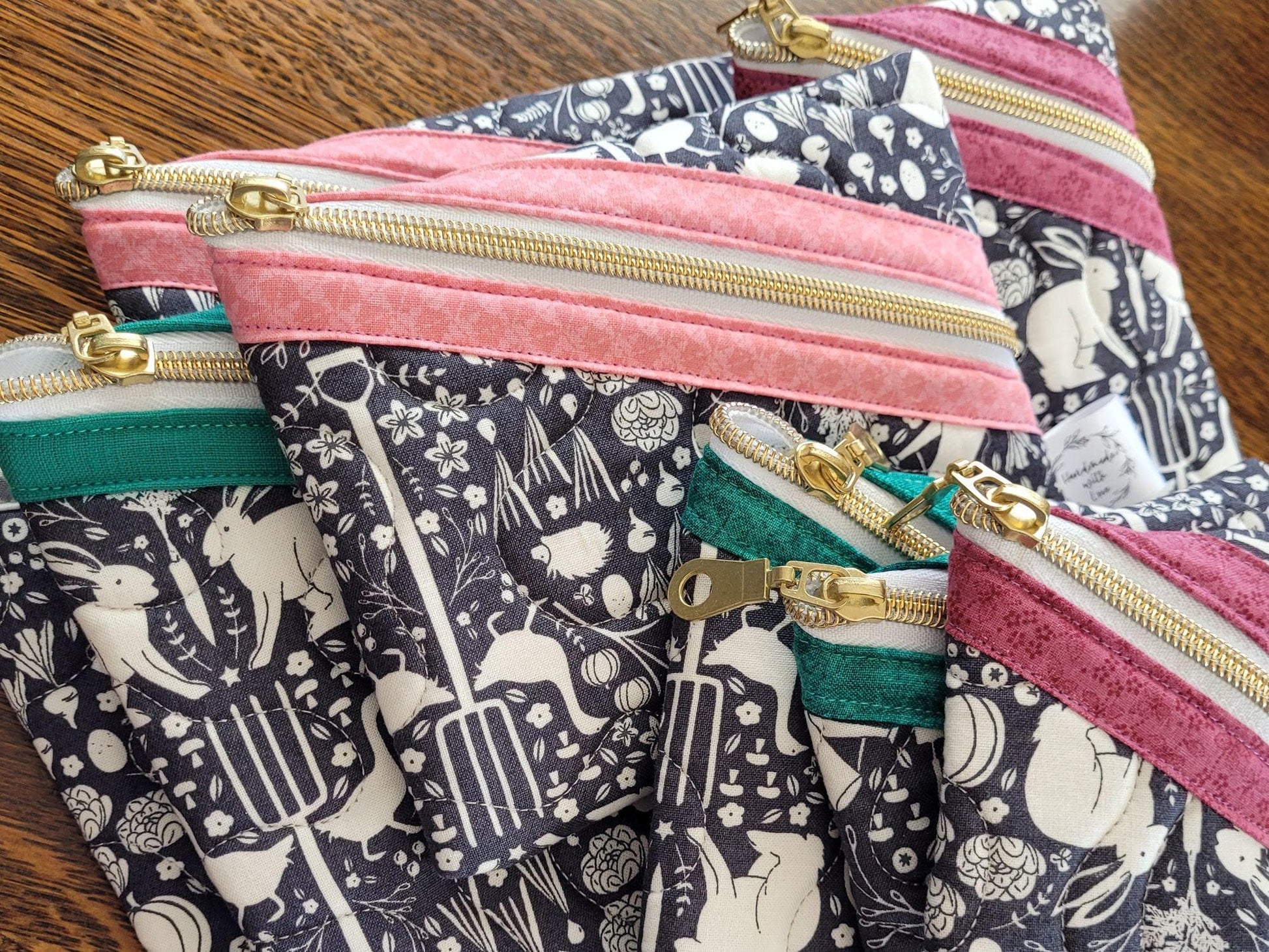 Quilted zipper pouches shown as a group of available sizes.