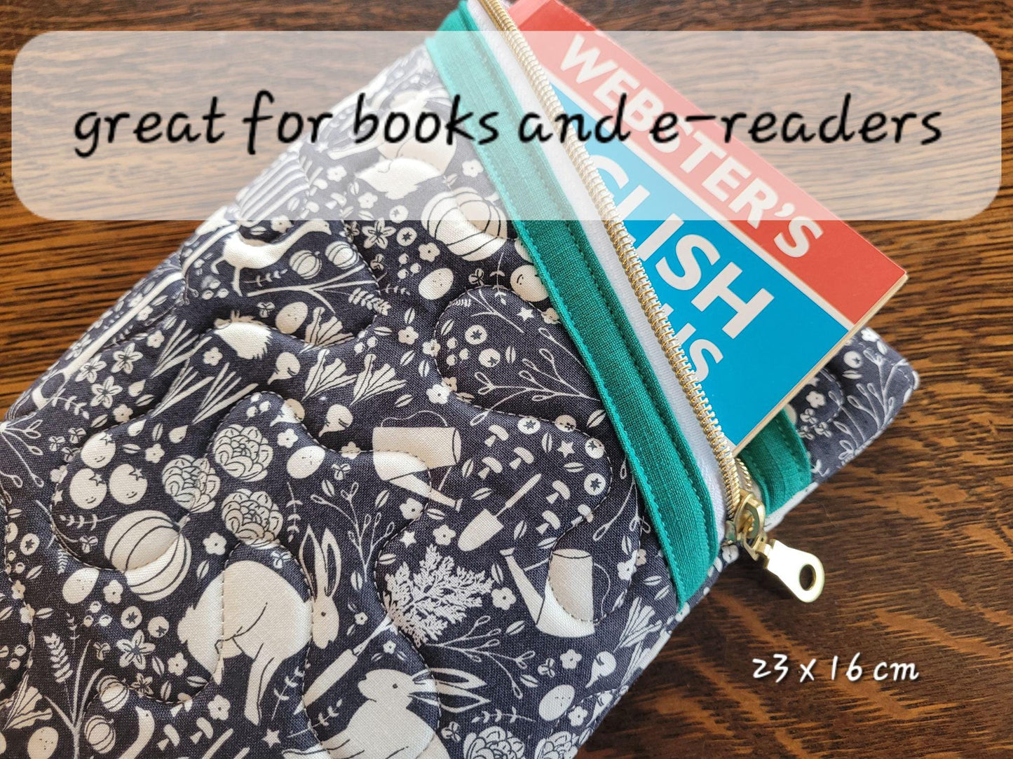 Quilted zipper pouch shown with a book. Perfect size for books and e-readers.